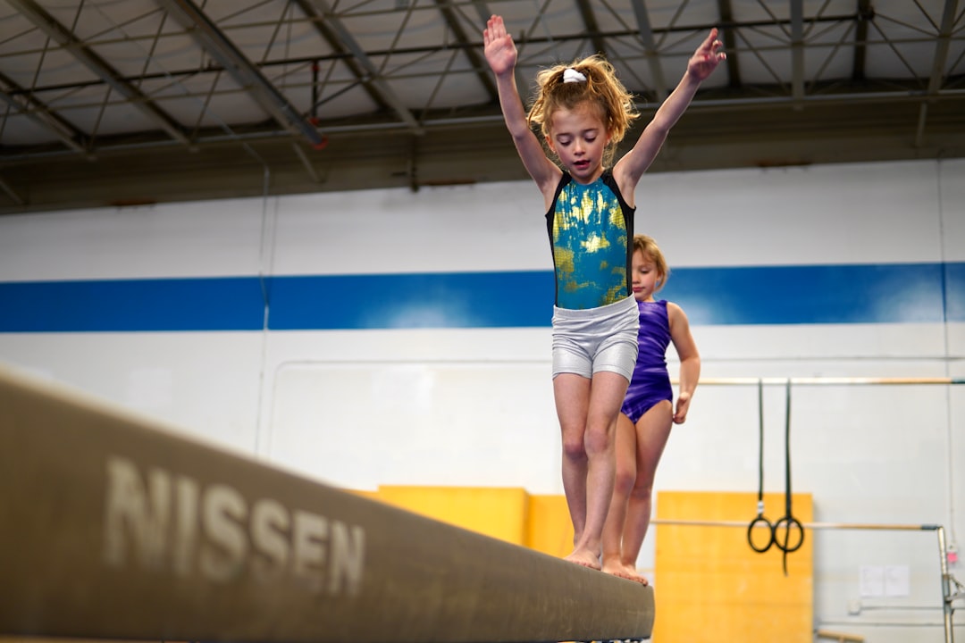 a-person-jumping-on-a-trampoline-with-a-child-in-the-background-iw3-4jth39o